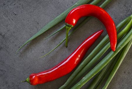Green onion, red pepper and garlic on dark grey table. Top view photo.の写真素材