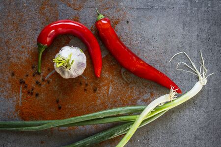 Green onion, red pepper and garlic on dark grey table. Top view photo.の写真素材