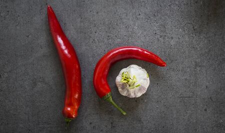 Red pepper and garlic on dark grey table. Top view photo.の写真素材
