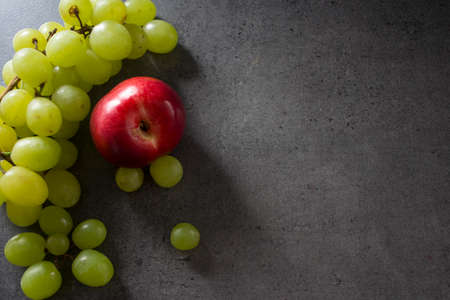 Colorful juicy fruits border.  Fresh summer fruits top view horizontal photo. Dark grey background with copy space.の写真素材