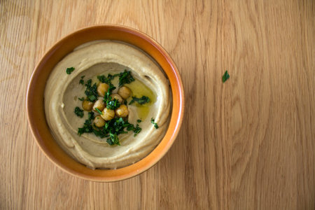 Food of Israel on a table. Top view photo of fresh made hummus, falafels and pita bread. Healthy...