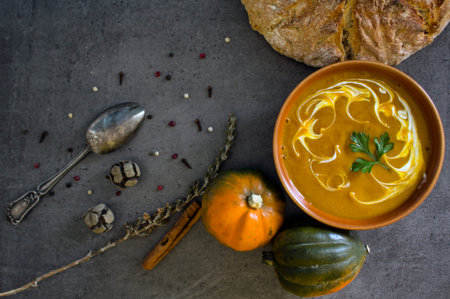 Pumpkin soup top view photo. Gray textured background. Healthy eating concept.の写真素材