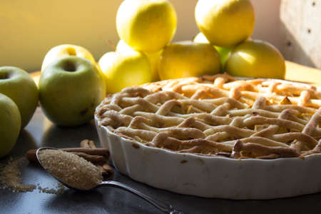 Apple pie with lattice decoration. Homemade dessert pie top view photo. Grey background.の写真素材