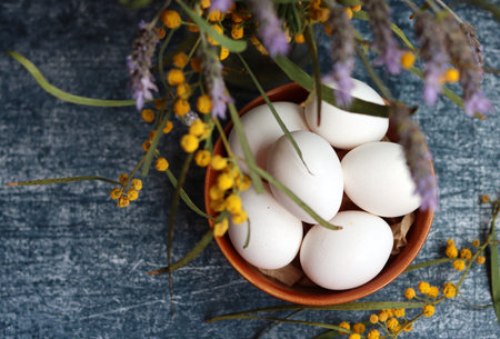 Simple composition still life with eggs. Easter card design. Still life with wild spring flowers in...