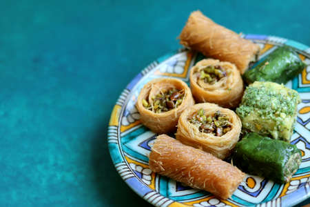 Colorful picture of Arabian sweets on decorative plate. Traditional dessert of Middle East. Food still life photo.の写真素材