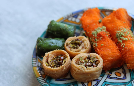Colorful picture of Arabian sweets on decorative plate. Traditional dessert of Middle East. Food...