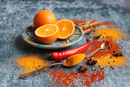 Aromatic spices on grey textured background with copy space. Colorful still life with herbs and...