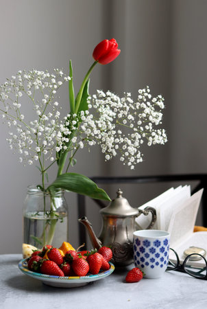 Colorful still life with strawberry and gypsophila flowers. Healthy eating concept. Summer is coming.の写真素材