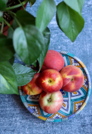 Still life with fresh organic fruit. Close up photo of nectarines and peaches on a table. Eating healthy concept.の写真素材