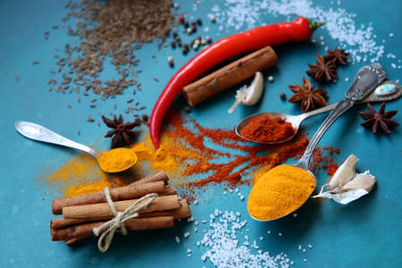 Colorful still life with different types of aroma spices. Vibrant colors of paprika, turmeric, chili pepper and anise star. Beautiful composition of spices.の写真素材