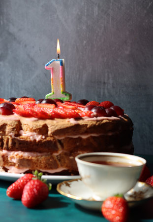 Colorful still life with Birthday cake and retro styled tableware. Strawberry cake on a table.