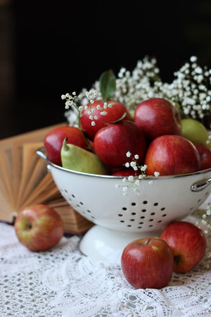 Still life with apples and pears in a colander, selective focusの写真素材