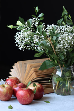 still life with books, apples and lily-of-the-valleyの写真素材