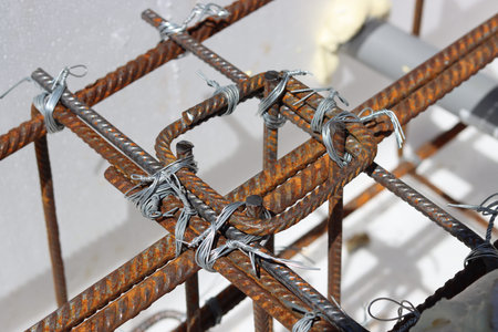 Iron mesh with barbed wire in the construction site, close-up. Reinforcement steel bars close up...