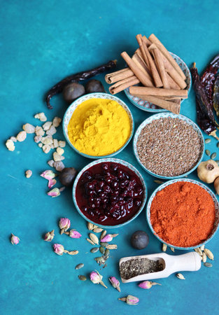 Spices and herbs on turquoise background. Food and cuisine ingredients.の写真素材