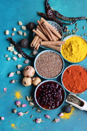 Spices and herbs on turquoise background. Food and cuisine ingredients.の写真素材