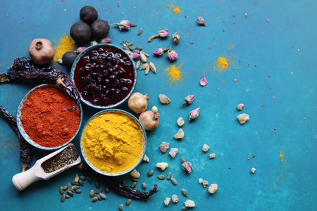 Spices and herbs on blue background. Food and cuisine ingredients.