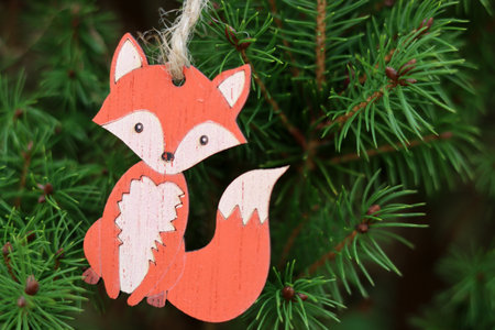 Wooden fox decoration on christmas tree. Christmas greeting card.の写真素材