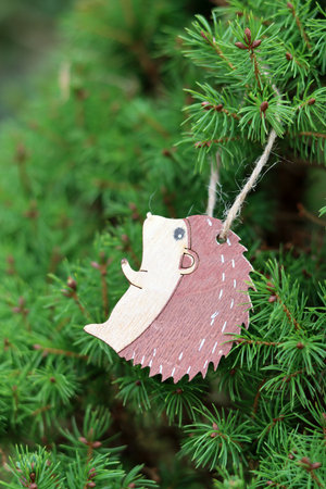 Wooden Christmas decoration hanging on the tree. Christmas card.の写真素材