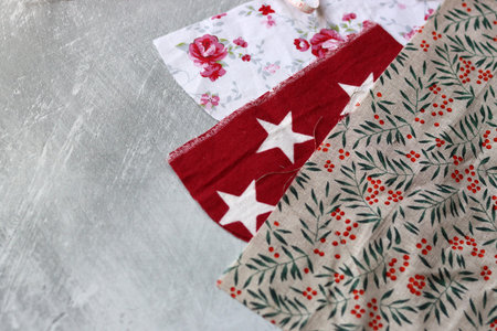 Different types of cotton fabric on light grey textured background with space for text. Sewing clothes of recycled fabric. Eco friendly fashion concept.の写真素材