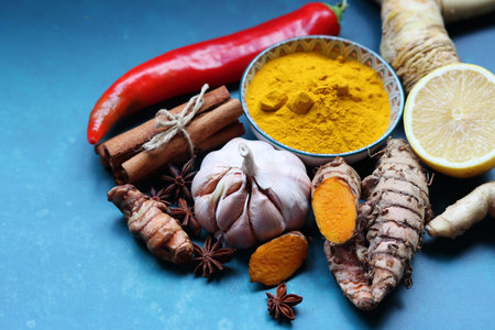 Ginger, turmeric, lemon and spices on a blue background Detox cocktail ingredients on a table. Top view photo of lemon, ginger and turmeric. Alternative medicine concept.の写真素材