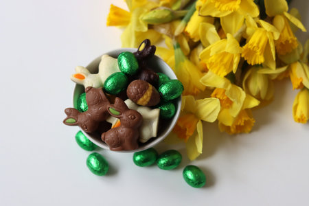 Chocolate candies and daffodils. Springtime holidays concept.の写真素材
