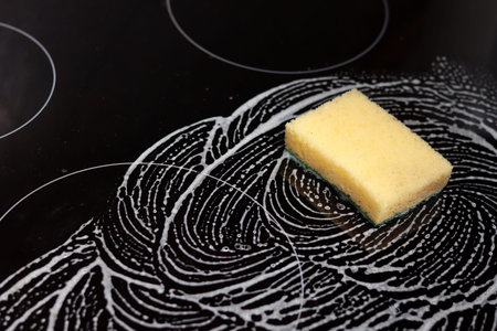 Sponge and sponge for washing dishes on a black background with a pattern