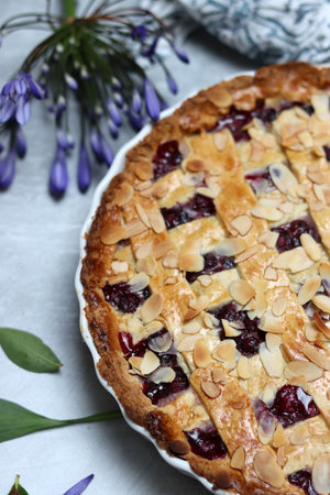 Freshly baked blueberry lattice pie on a table. Beautiful golden crust close up photo. Sweet homemade round cake. Light gray background with space for text.の写真素材