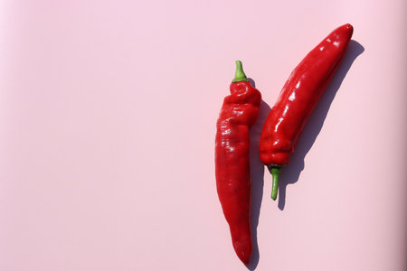 Red hot chili peppers on pink background. Minimal food concept.の写真素材