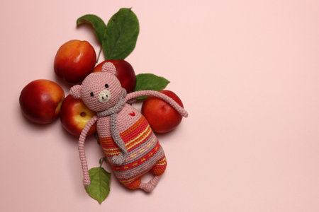 Teddy bear with fruits and leaves on a pink background.の写真素材