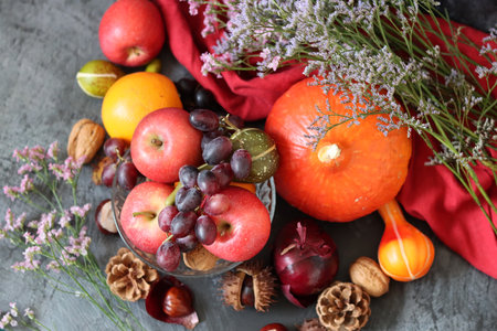 Autumn still life with pumpkins, apples, grapes and nutsの写真素材