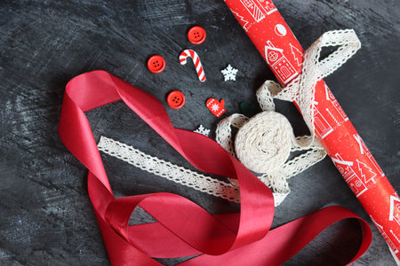 Christmas background with red ribbons and decorations on dark background, top viewの写真素材