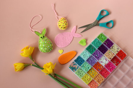 Easter decoration with colorful eggs and spring flowers on a pink backgroundの写真素材