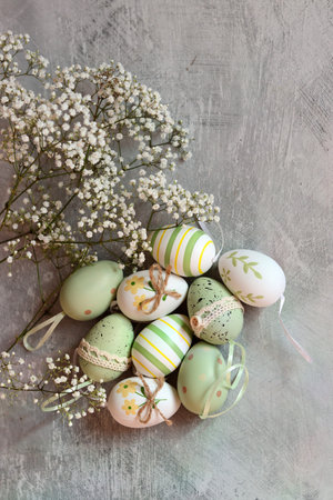 Easter eggs with gypsophila flowers on a gray background