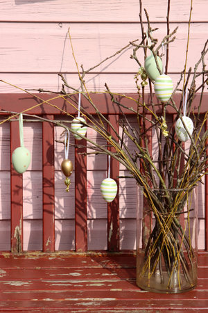 Easter eggs in a vase on the porch of the house