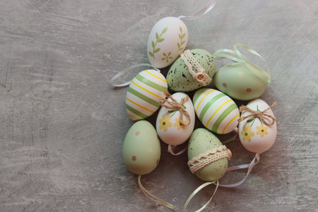 Easter eggs in pastel colors on a gray concrete background with space for text