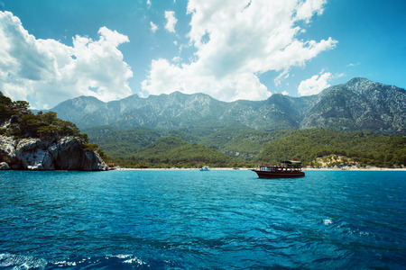 A boat is sailing against the picturesque sea view.の写真素材