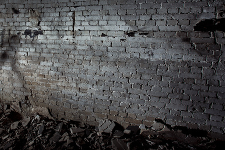Image of grey aged ruined dark wall with concrete pieces on floor. Concept of horror movie.の写真素材
