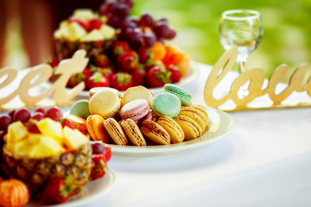 Closeup image of fresh fruits and berries and cookies at a white table background.の写真素材