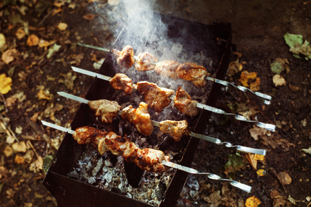 Closeup image of preparation of fresh tasty grilled shashlik outdoors at summer background.の写真素材
