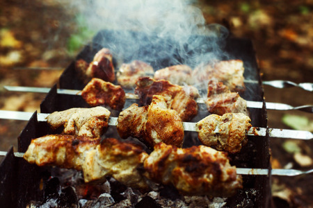 Closeup image of preparation of fresh tasty grilled shashlik outdoors at summer background.の写真素材