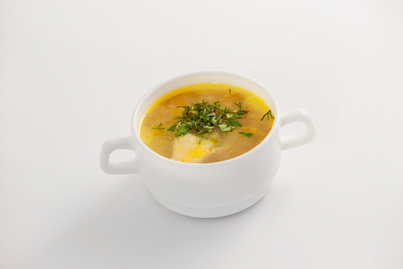 Closeup image of bowl with fresh chicken soup isolated at white background.の写真素材