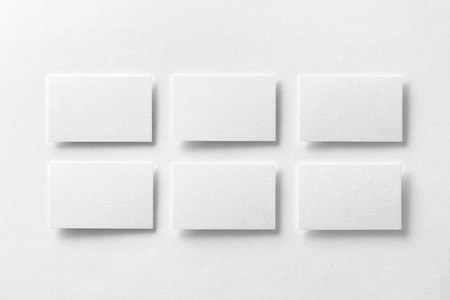 Mockup of white business cards arranged in rows at white design paper background.の写真素材