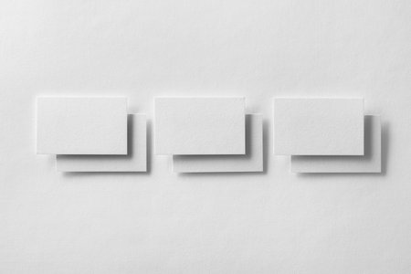 Mockup of business cards rows at white textured paper background.