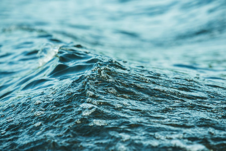 Closeup image of water waves outdoors at sea background.の写真素材