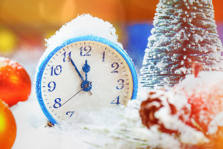 New year greeting card with clock at festive background.の写真素材