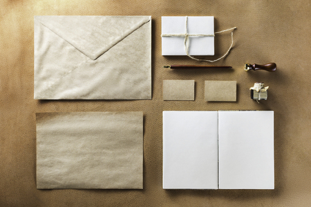 Mockup of vintage set of stationery including envelope, letterhead, notepad, business cards at brown shammy leather background.の写真素材