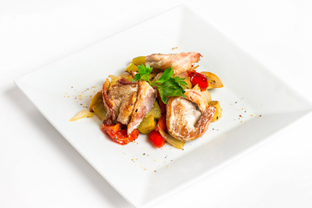 Closeup image of bbq shashlik with vegetables on plate isolated at white background.の写真素材