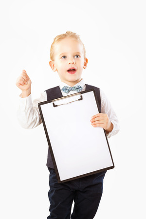 Isolated portrait of little boy in suit with clipboard making thumb up gesture as a business concept.の写真素材