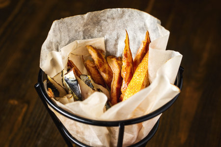 Closeup image of spelding fish beer set at wooden board background.